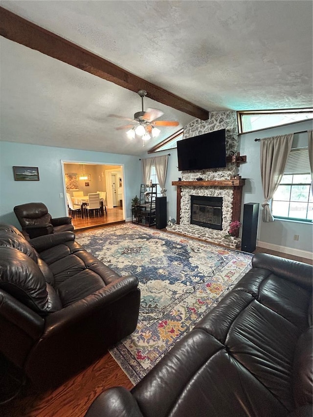 2070 SE 50th Ter, Ocala, FL 34480 - living area featuring a ceiling fan, wood finished floors, a fireplace, and a textured ceiling