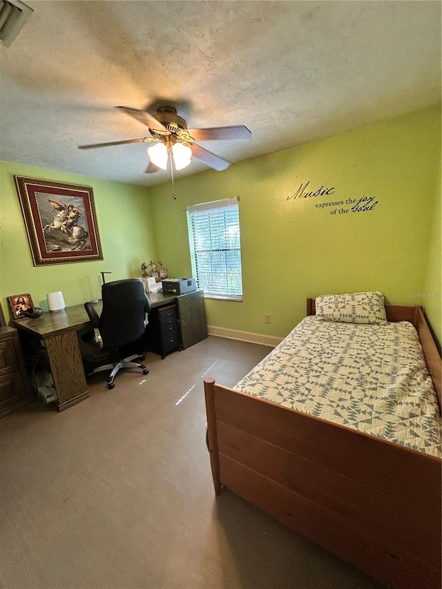 2070 SE 50th Ter, Ocala, FL 34480 - bedroom featuring an office area, carpet floors, a textured ceiling, and a ceiling fan