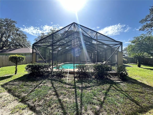 2070 SE 50th Ter, Ocala, FL 34480 - rear view of house featuring a fenced backyard and glass enclosure