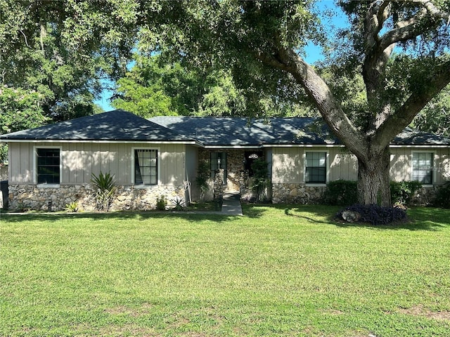 2070 SE 50th Ter, Ocala, FL 34480 - ranch-style house featuring stone siding, a front lawn, and a shingled roof