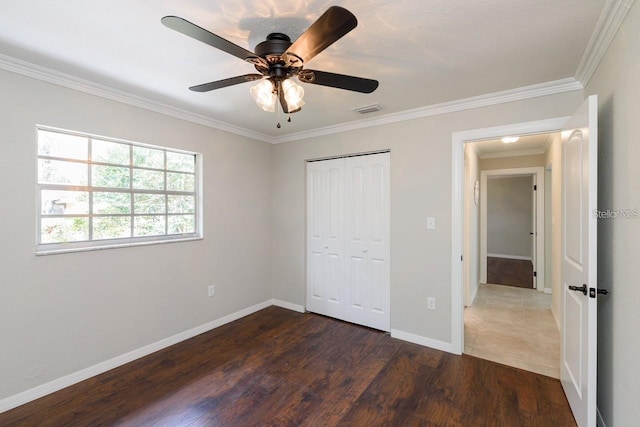 5002 SE 7th Pl, Ocala, FL 34471 - unfurnished bedroom with dark wood finished floors, crown molding, a closet, and a ceiling fan