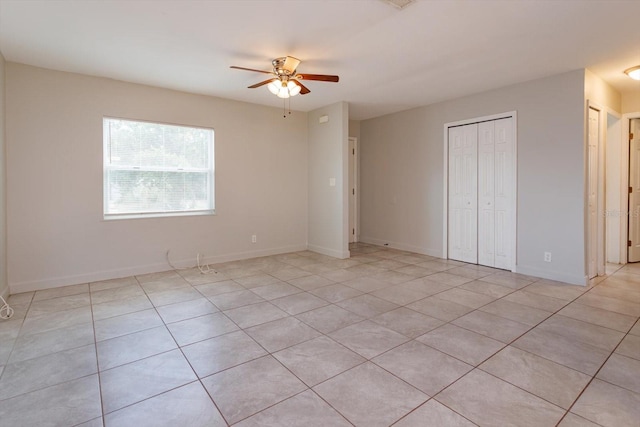 956 Osceola Trl, Casselberry, FL 32707 - unfurnished bedroom with light tile patterned floors, a ceiling fan, and a closet
