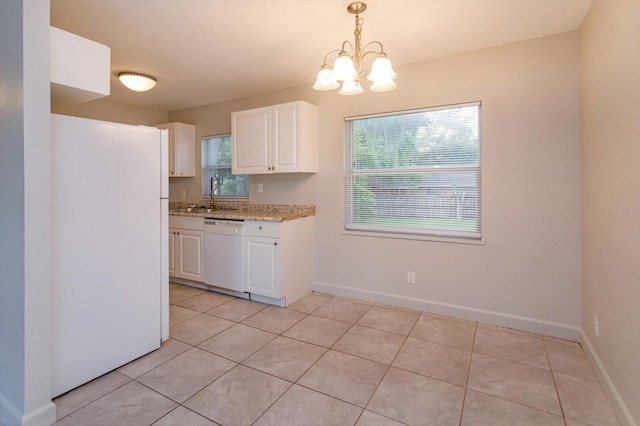 956 Osceola Trl, Casselberry, FL 32707 - kitchen featuring white appliances, white cabinets, light tile patterned floors, and a chandelier