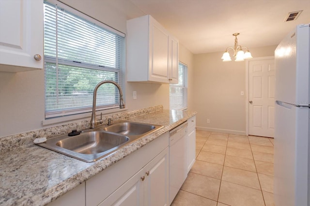 956 Osceola Trl, Casselberry, FL 32707 - kitchen featuring white appliances, white cabinets, light countertops, and a chandelier