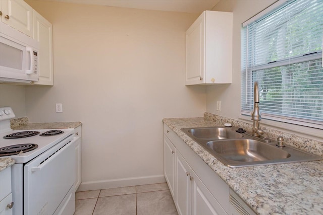 956 Osceola Trl, Casselberry, FL 32707 - kitchen featuring white appliances, white cabinetry, light countertops, and light tile patterned flooring