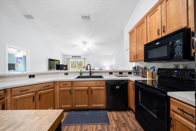 3946 SW 133rd Loop, Ocala, FL 34473 - kitchen featuring black appliances, vaulted ceiling, light countertops, dark wood finished floors, and a ceiling fan