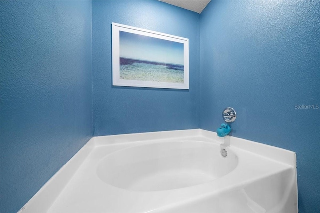 3946 SW 133rd Loop, Ocala, FL 34473 - bathroom featuring a garden tub and a textured wall