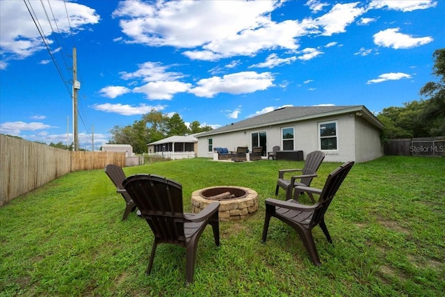 3946 SW 133rd Loop, Ocala, FL 34473 - back of property with a fire pit, a fenced backyard, stucco siding, and a patio area