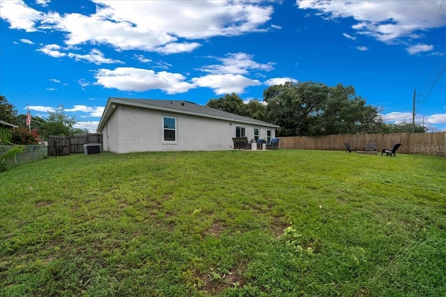 3946 SW 133rd Loop, Ocala, FL 34473 - rear view of property with stucco siding and a fenced backyard