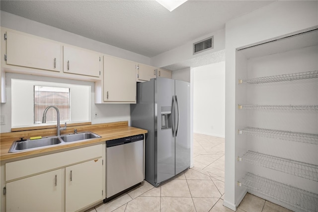 2701 NE 10th St Unit 403, Ocala, FL 34470 - kitchen with stainless steel appliances, light countertops, light tile patterned flooring, and a textured ceiling