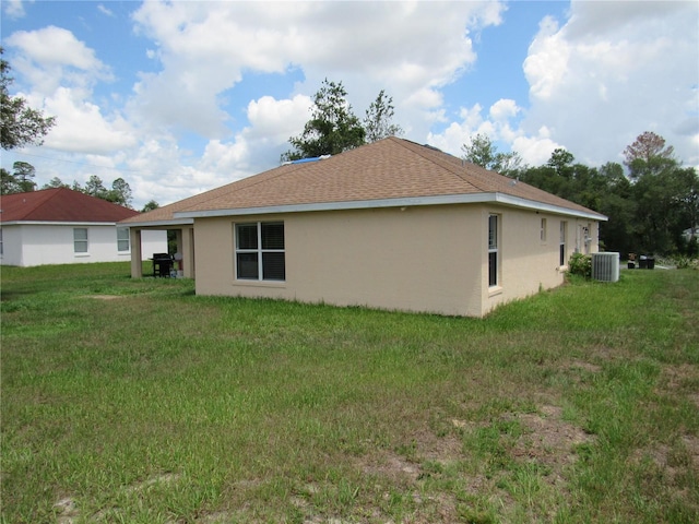 2640 SW 154th Place Rd, Ocala, FL 34473 - back of property featuring stucco siding, a lawn, and a shingled roof