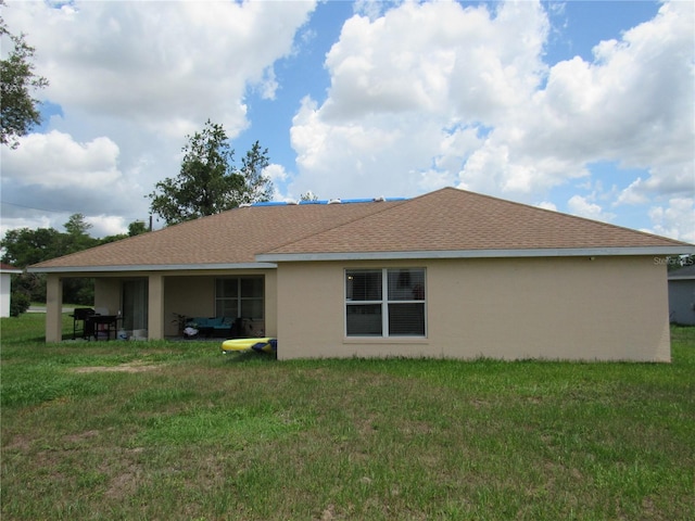 2640 SW 154th Place Rd, Ocala, FL 34473 - rear view of property with stucco siding, a lawn, and a shingled roof
