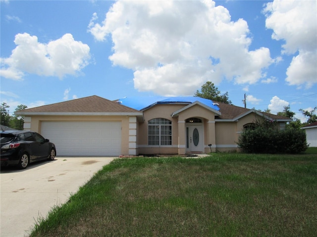 2640 SW 154th Place Rd, Ocala, FL 34473 - ranch-style house featuring stucco siding, driveway, an attached garage, and a front lawn