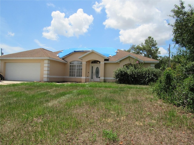 2640 SW 154th Place Rd, Ocala, FL 34473 - ranch-style home with stucco siding, an attached garage, and a front yard