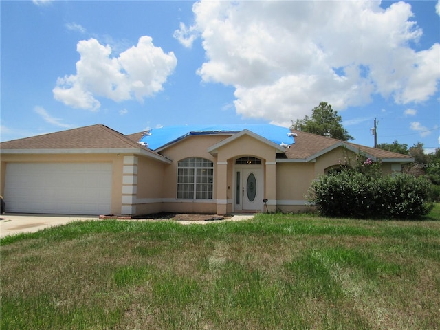 2640 SW 154th Place Rd, Ocala, FL 34473 - ranch-style home featuring stucco siding, an attached garage, driveway, and a front yard