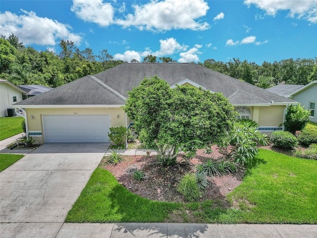 5210 Camberlea Ave, Zephyrhills, FL 33541 - view of front facade featuring a garage, driveway, stucco siding, a front yard, and a shingled roof