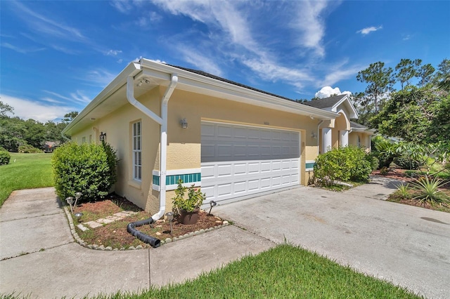 5210 Camberlea Ave, Zephyrhills, FL 33541 - view of property exterior with concrete driveway, an attached garage, and stucco siding