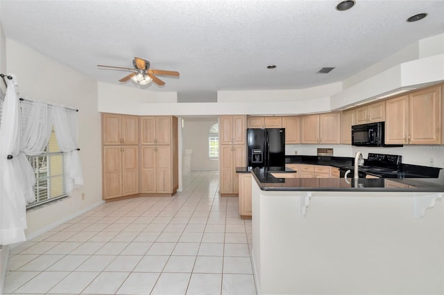 5210 Camberlea Ave, Zephyrhills, FL 33541 - kitchen featuring black appliances, dark countertops, a ceiling fan, light brown cabinetry, and a textured ceiling