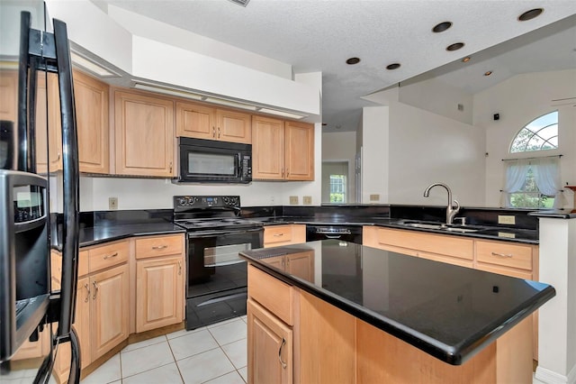 5210 Camberlea Ave, Zephyrhills, FL 33541 - kitchen featuring black appliances, dark countertops, a peninsula, a kitchen island, and light brown cabinets
