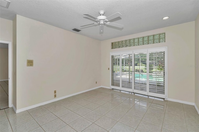 5210 Camberlea Ave, Zephyrhills, FL 33541 - empty room featuring light tile patterned floors, a textured ceiling, a ceiling fan, and recessed lighting