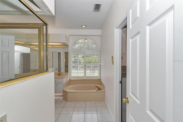 5210 Camberlea Ave, Zephyrhills, FL 33541 - full bath with tile patterned flooring, a bath, vanity, recessed lighting, and a textured ceiling