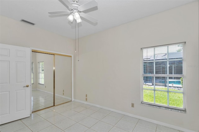 5210 Camberlea Ave, Zephyrhills, FL 33541 - unfurnished bedroom with light tile patterned floors, a closet, and ceiling fan