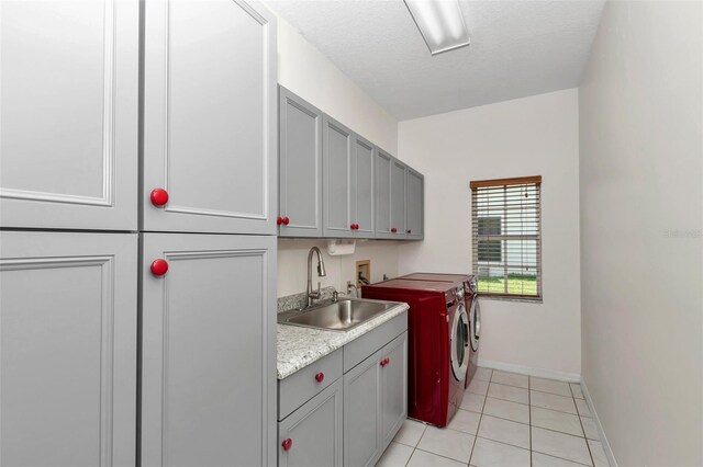 5210 Camberlea Ave, Zephyrhills, FL 33541 - laundry room with cabinet space, washer and clothes dryer, and light tile patterned floors