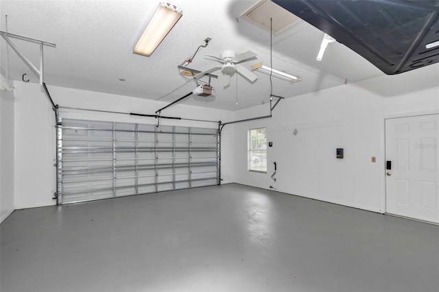 5210 Camberlea Ave, Zephyrhills, FL 33541 - garage with a garage door opener and a ceiling fan