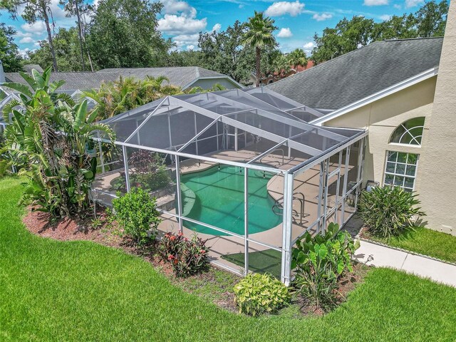 5210 Camberlea Ave, Zephyrhills, FL 33541 - view of property exterior featuring an outdoor pool, stucco siding, a patio, a yard, and glass enclosure