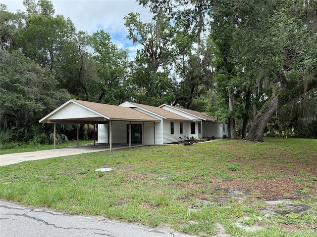 3585 N Hiawatha Ter, Crystal River, FL 34428 - single story home with concrete driveway, a front lawn, and a carport
