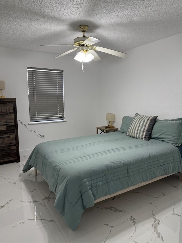 3585 N Hiawatha Ter, Crystal River, FL 34428 - bedroom featuring marble tiled floors, ceiling fan, and a textured ceiling