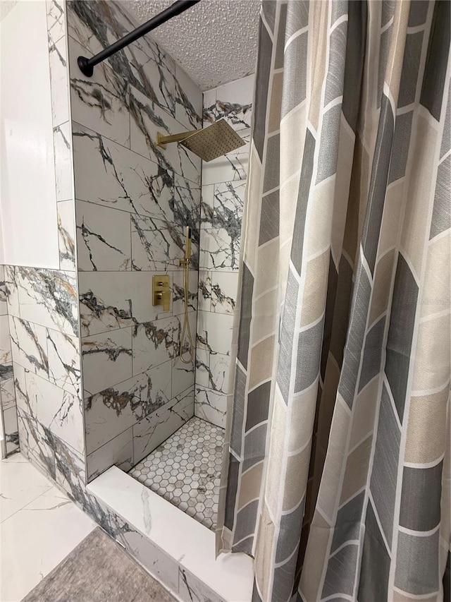3585 N Hiawatha Ter, Crystal River, FL 34428 - bathroom with a tile shower, marble finish floors, and a textured ceiling