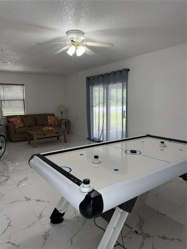 3585 N Hiawatha Ter, Crystal River, FL 34428 - playroom featuring marble finish flooring, a textured ceiling, and ceiling fan