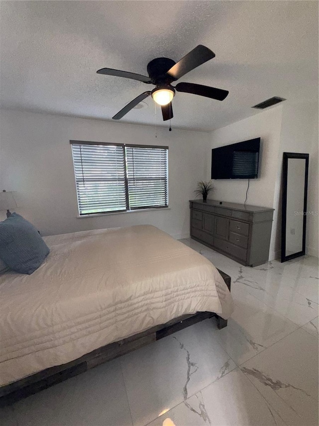 3585 N Hiawatha Ter, Crystal River, FL 34428 - bedroom with marble finish floors, ceiling fan, and a textured ceiling