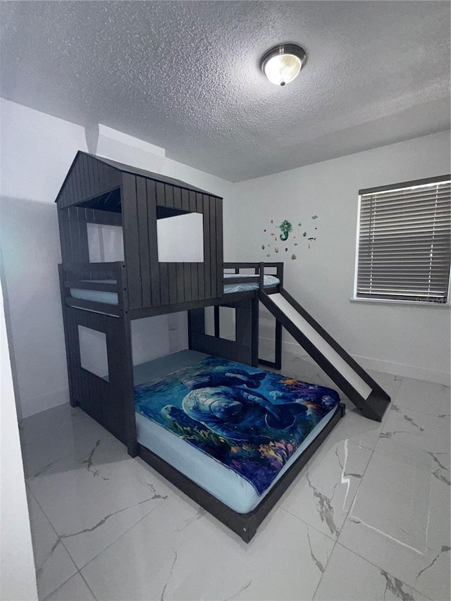 3585 N Hiawatha Ter, Crystal River, FL 34428 - bedroom featuring marble look tiles and a textured ceiling