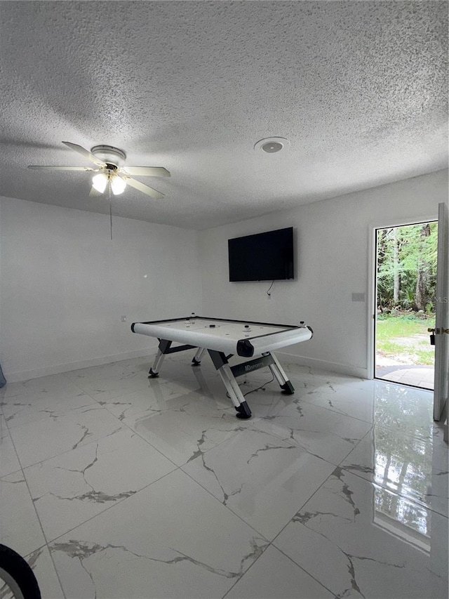 3585 N Hiawatha Ter, Crystal River, FL 34428 - game room with marble look tile flooring, a textured ceiling, and a ceiling fan