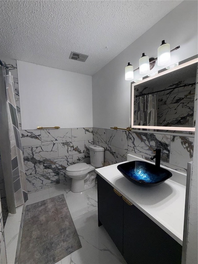 3585 N Hiawatha Ter, Crystal River, FL 34428 - bathroom featuring tile walls, vanity, a shower with shower curtain, marble finish flooring, and a wainscoted wall