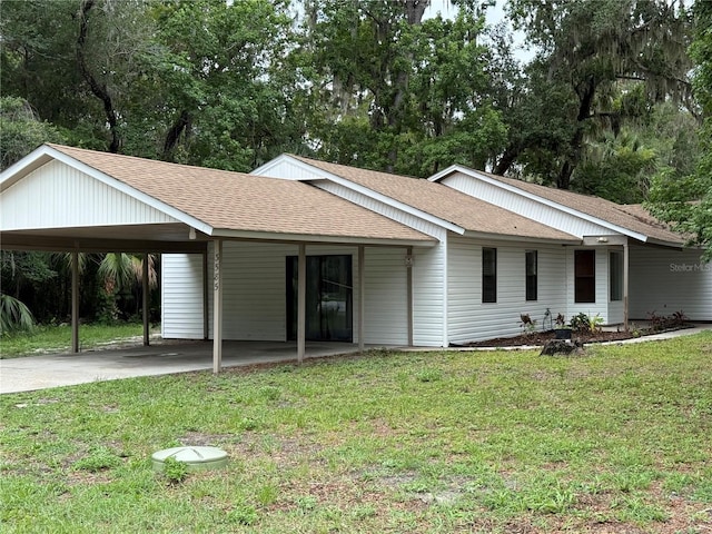 3585 N Hiawatha Ter, Crystal River, FL 34428 - ranch-style house with a carport, concrete driveway, a shingled roof, and a front lawn