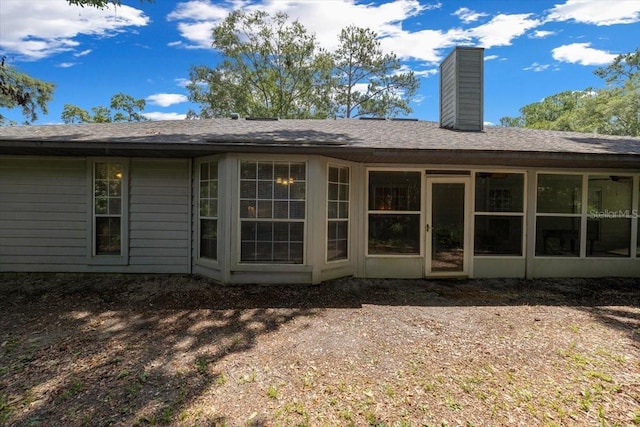 3520 NW 46th Ter, Gainesville, FL 32606 - rear view of house with a chimney and a shingled roof