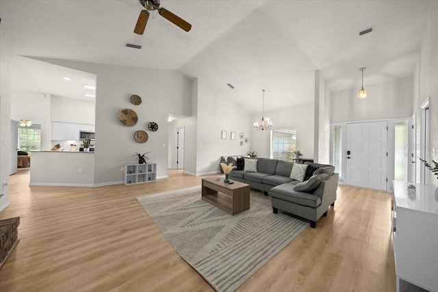 3520 NW 46th Ter, Gainesville, FL 32606 - living room featuring a ceiling fan, high vaulted ceiling, light wood-style flooring, and a chandelier