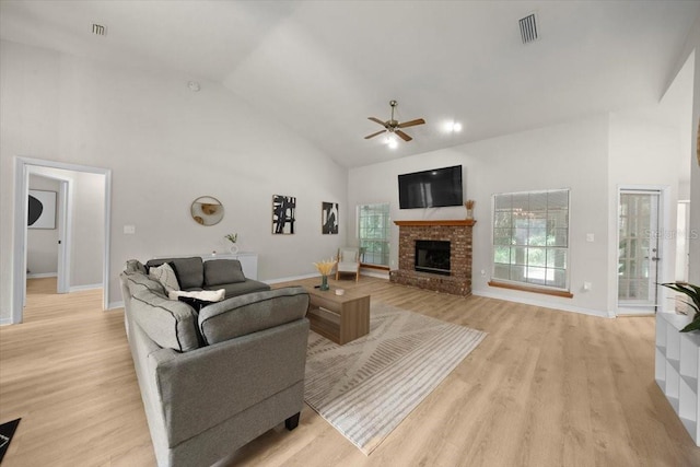 3520 NW 46th Ter, Gainesville, FL 32606 - living area with high vaulted ceiling, ceiling fan, a brick fireplace, and light wood-type flooring