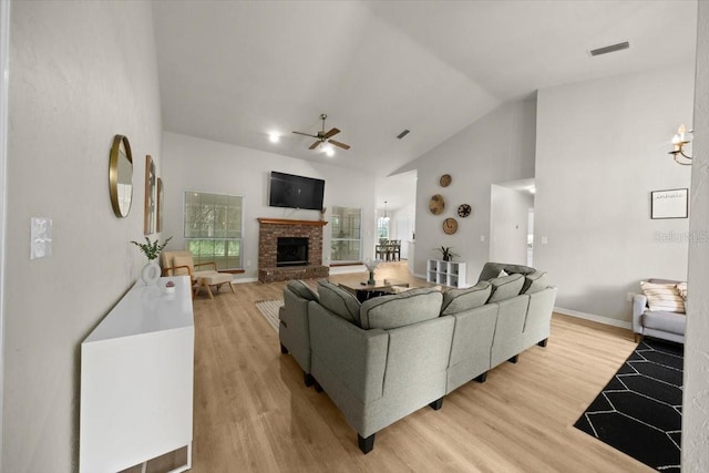 3520 NW 46th Ter, Gainesville, FL 32606 - living area with a ceiling fan, a fireplace, light wood-type flooring, and high vaulted ceiling
