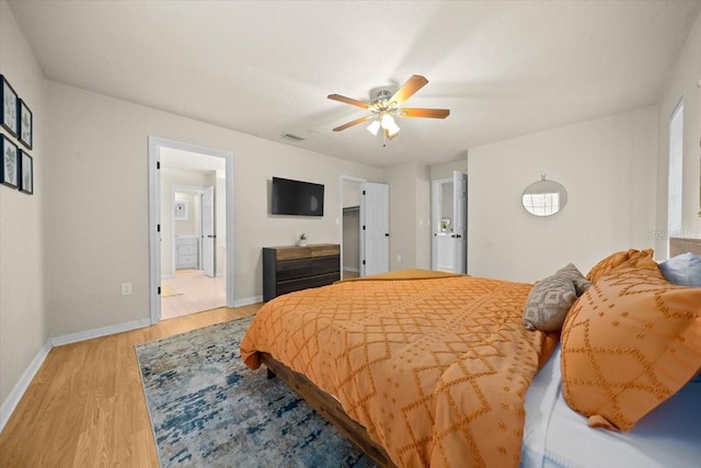 3520 NW 46th Ter, Gainesville, FL 32606 - bedroom featuring light wood-style floors, a ceiling fan, and ensuite bath