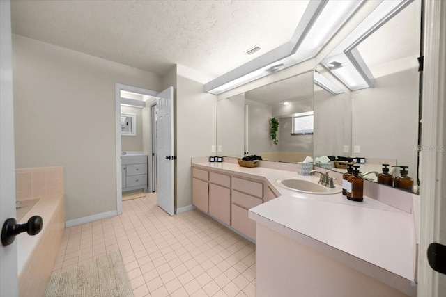 3520 NW 46th Ter, Gainesville, FL 32606 - full bath featuring vanity, a bath, tile patterned floors, and a textured ceiling