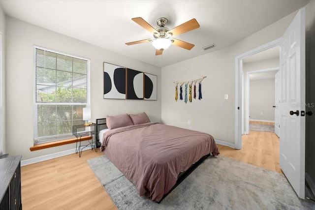 3520 NW 46th Ter, Gainesville, FL 32606 - bedroom with light wood-style floors and a ceiling fan