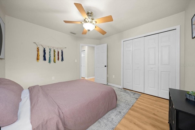 3520 NW 46th Ter, Gainesville, FL 32606 - bedroom with light wood-style flooring, a closet, and a ceiling fan