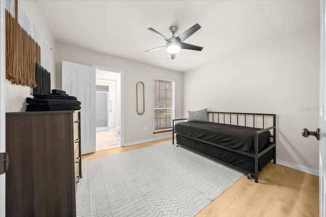 3520 NW 46th Ter, Gainesville, FL 32606 - bedroom featuring light wood finished floors, ensuite bathroom, and a ceiling fan