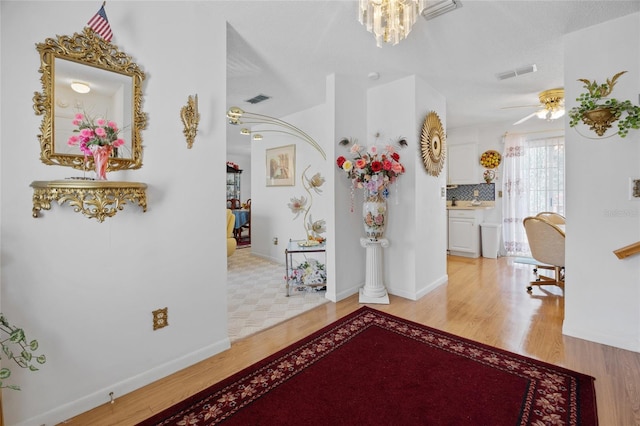 6 Emerald Crse, Ocala, FL 34472 - hallway with light wood-style flooring and a chandelier
