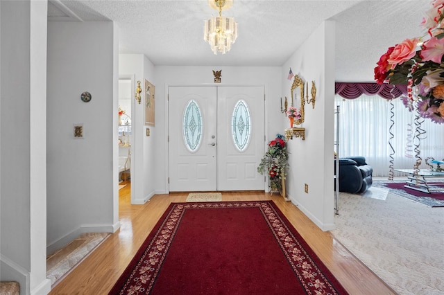 6 Emerald Crse, Ocala, FL 34472 - entryway featuring light wood-style flooring, a chandelier, and a textured ceiling