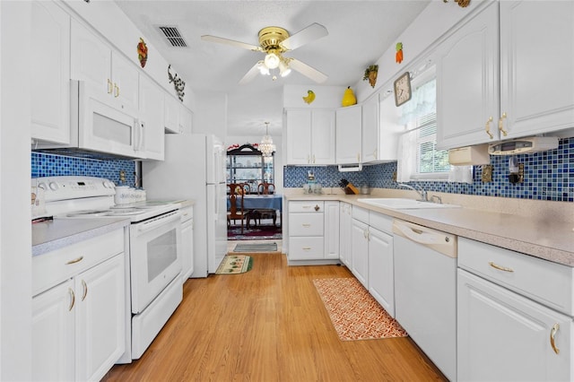 6 Emerald Crse, Ocala, FL 34472 - kitchen with white appliances, light wood finished floors, light countertops, white cabinetry, and a ceiling fan